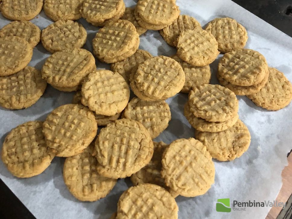 Hilda Gerbrandt (left), and younger sister Rose Froese (right), stop by the radio station with a tray of delicious homemade Christmas baking