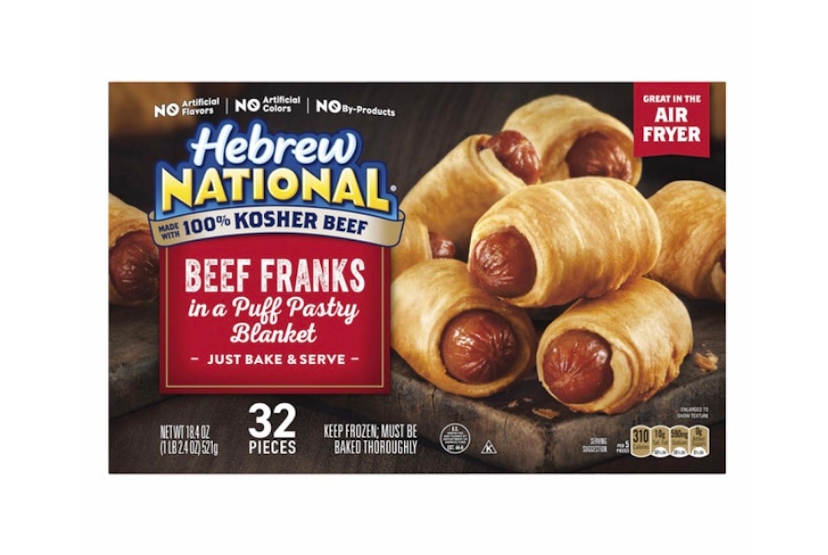 A box of Hebrew National Beef Franks in a Puff Pastry Blanket. The package shows several pigs in a blanket and highlights "Great in the Air Fryer", "32 pieces", and "100% Kosher Beef".