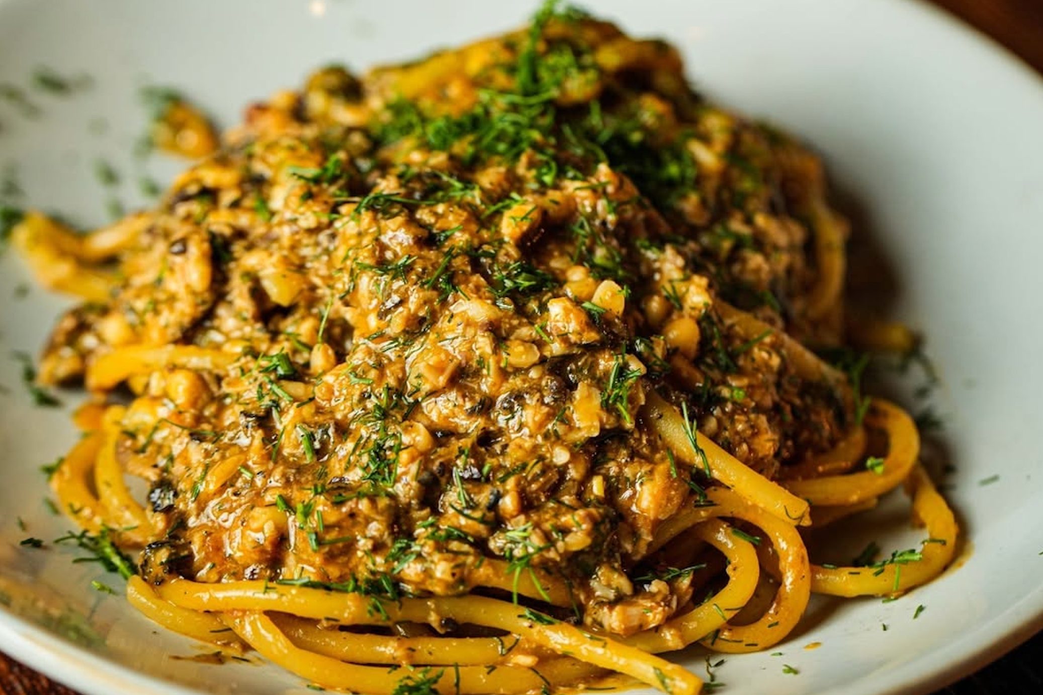 Bucatini alle Sarde on white plate