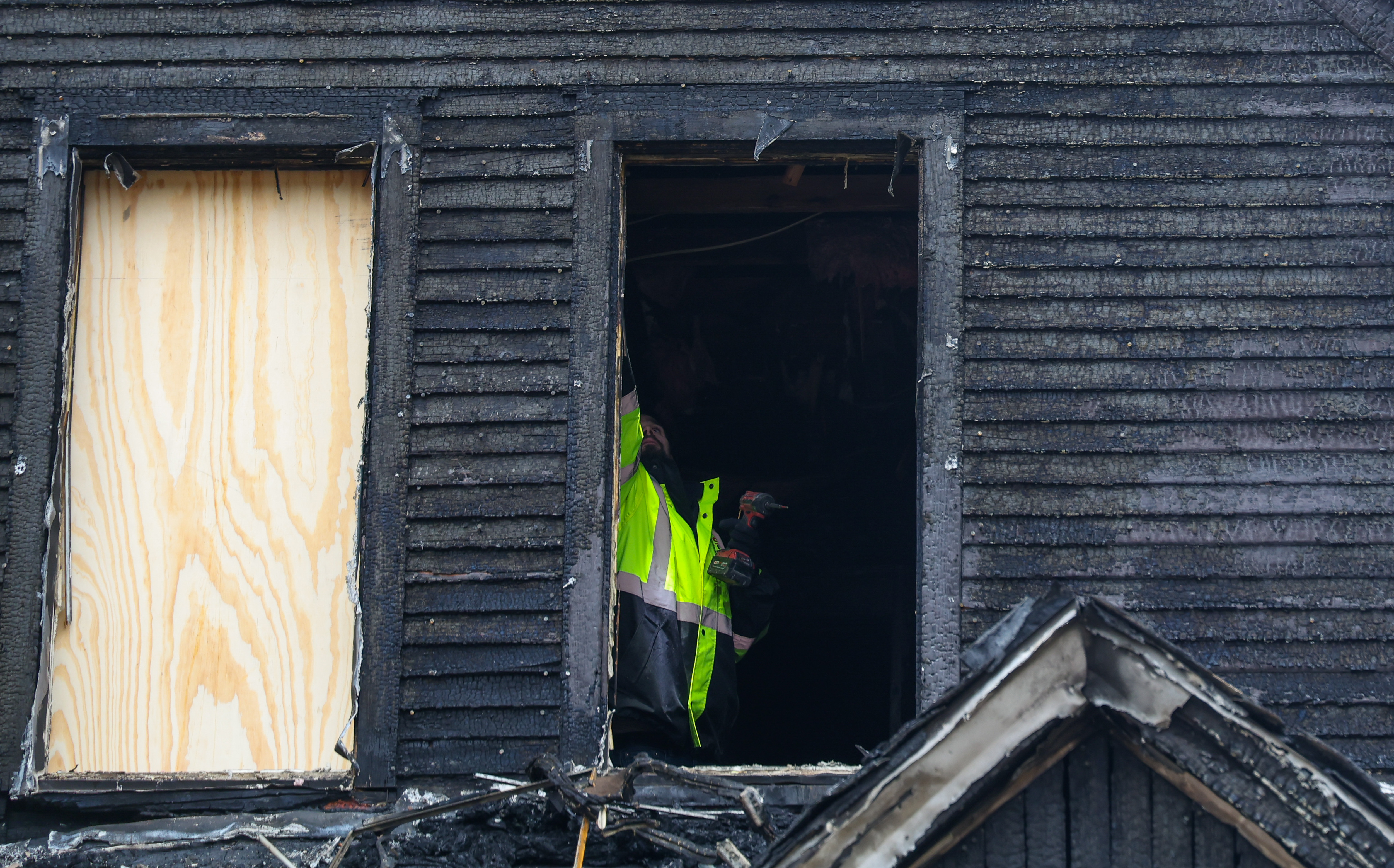 Timothy Moore, with 911 Fire Board-Up and Construction, boards up...
