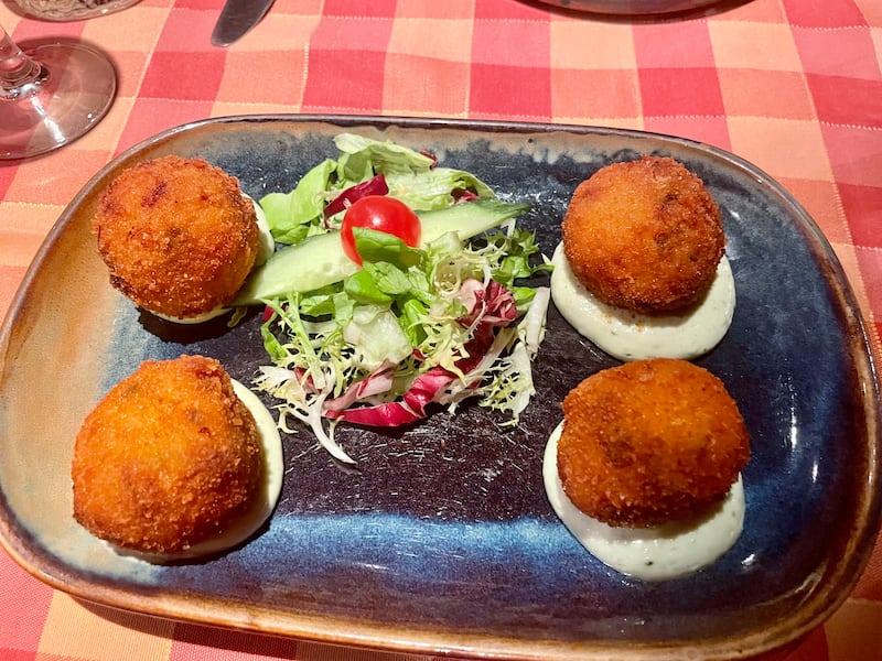 A plate of four arancini