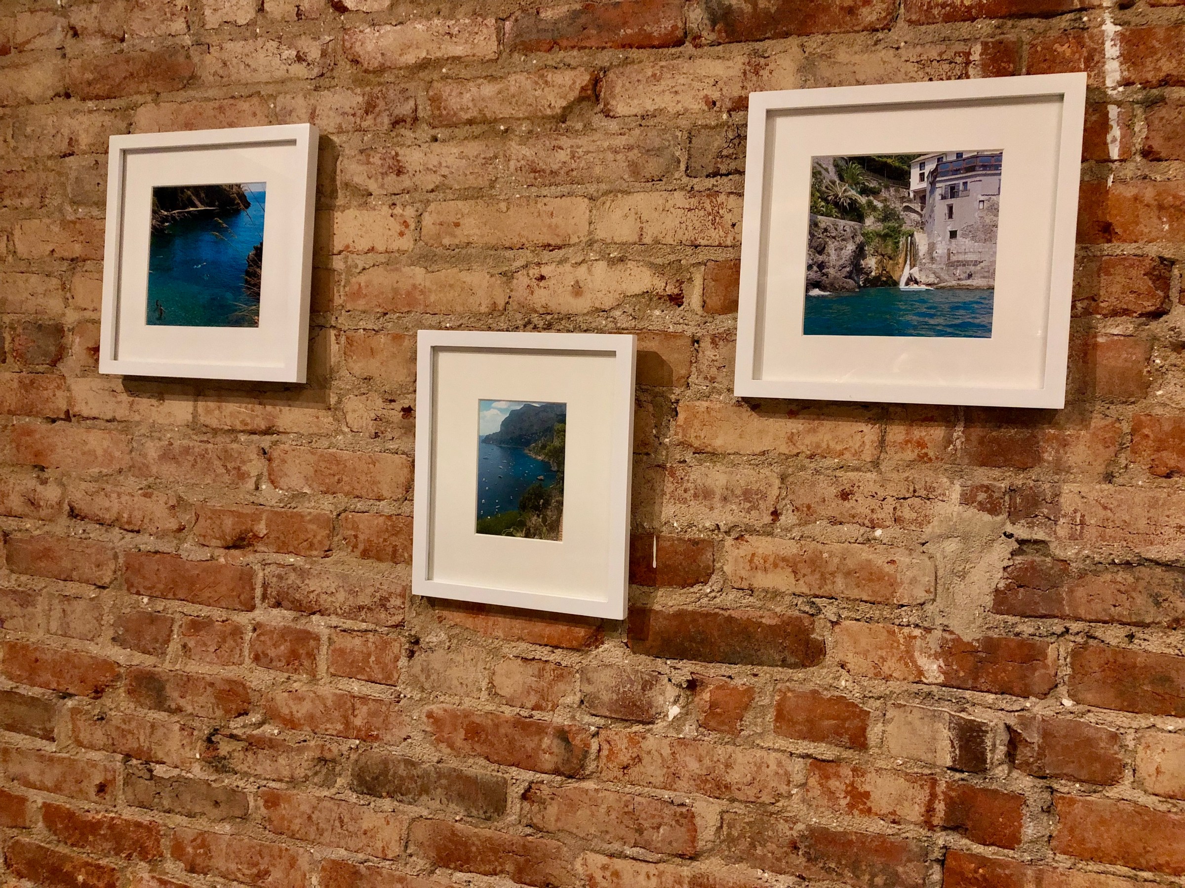 Framed photos of Italy’s idyllic destinations like Positano and caves in Capri are joined by family photos of the owner’s son, niece, and mom on beach vacations.