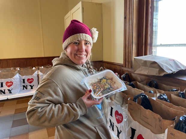 Angel Food East Kitchen Manager Fiona McElroy shows off a meal that was set be delivered to a homebound individual the non-profit serves on Thursday, Dec.18, 2025, at Angel Food's headquarters at the St. John's Episcopal Church at 207 Albany Ave, Kingston. (Brian Hubert, Daily Freeman)