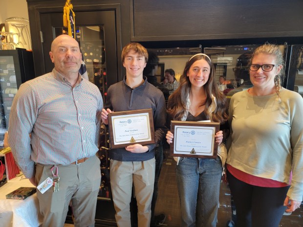 Penncrest High School Assistant Principal Joe Fuhr, left, and Rotarian Courtney Ballauer, right, chair of the Rotary's student of the month, congratulate Penncrest students Paul Graham and Parker Caruso on receiving December's students-of-the-month honor. (COURTESY OF MEDIA ROTARY CLUB)