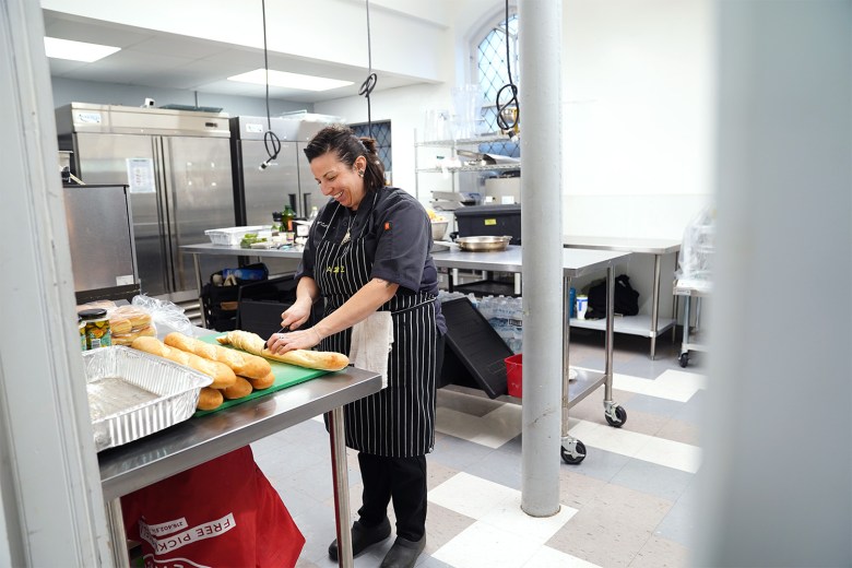 Chef Cat Alaimo, co-founder and owner of A 2 Z Living Well Solutions, prepares bruschetta at The Well CDC's Akron Food Works on Thursday, Nov. 20.