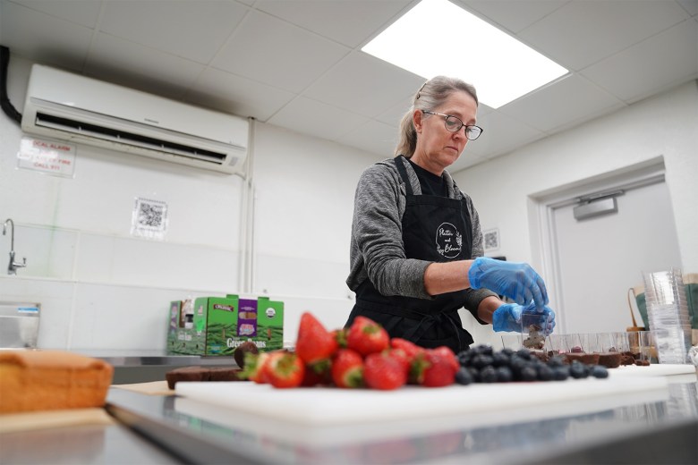Platter and Bloom kitchen assistant Marci Bucciarelli  prepares pudding cups at The Well CDC's Akron Food Works 