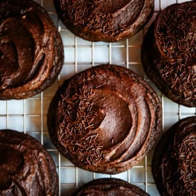 These easy Chocolate Frosted Cookies combine soft chocolate cookies with a rich, chocolate buttercream frosting. The double chocolate cookie base is filled with melty chocolate chips and a smooth cocoa frosting on top. These Frosted Chocolate Cookies are a chocolate lover’s dream.