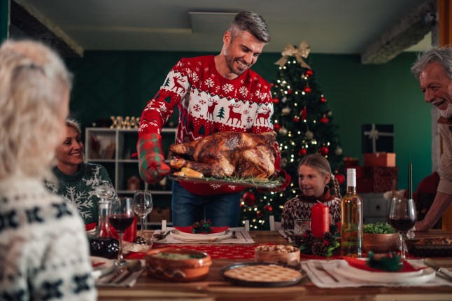 Family enjoying christmas dinner with roasted turkey
