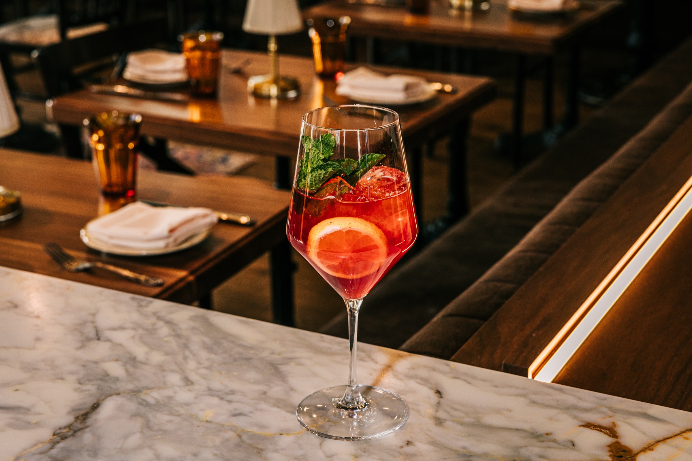 A Tutto Spritz cocktail on a counter.