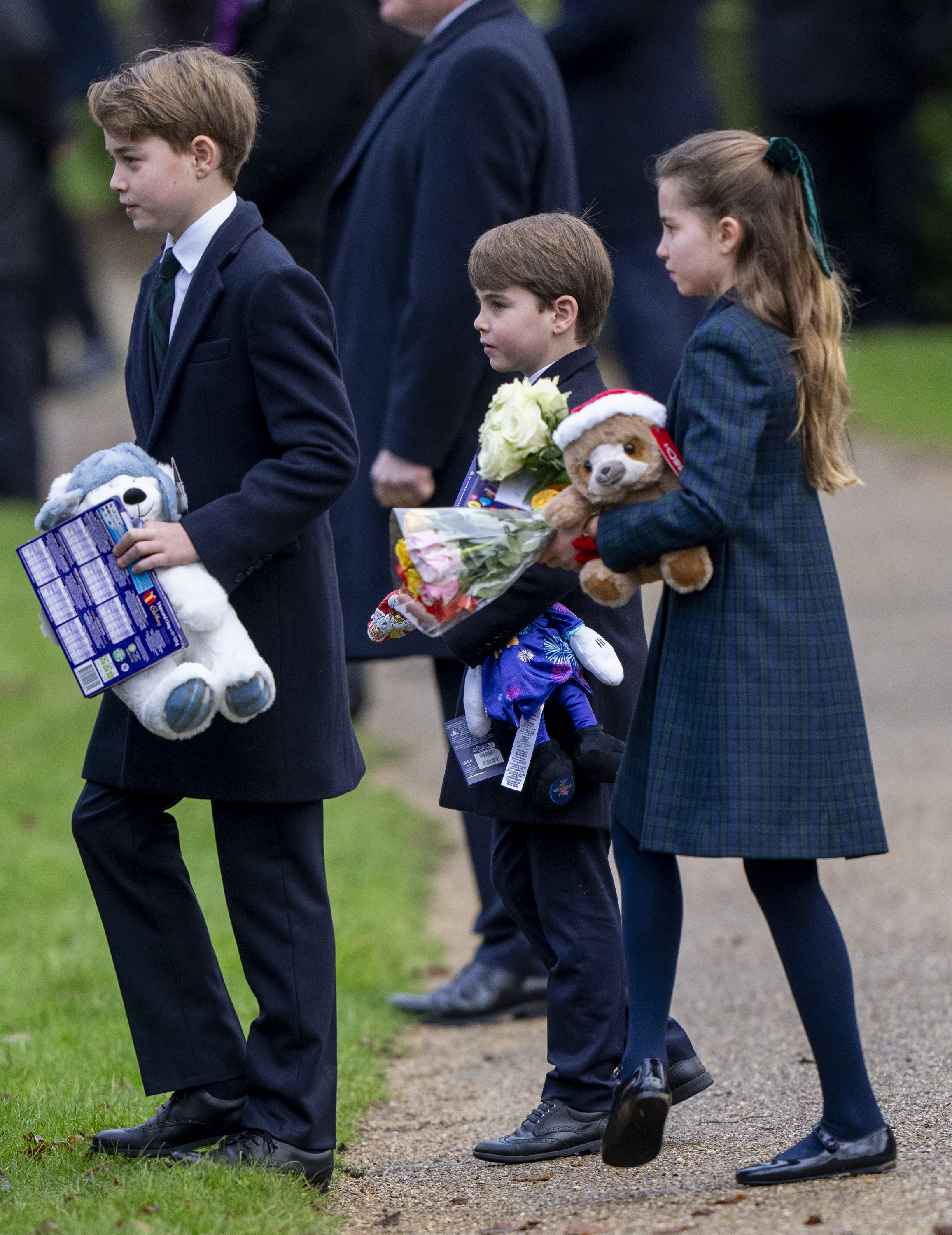 Prince George, Prince Louis and Princess Charlotte holding gifts on Christmas day