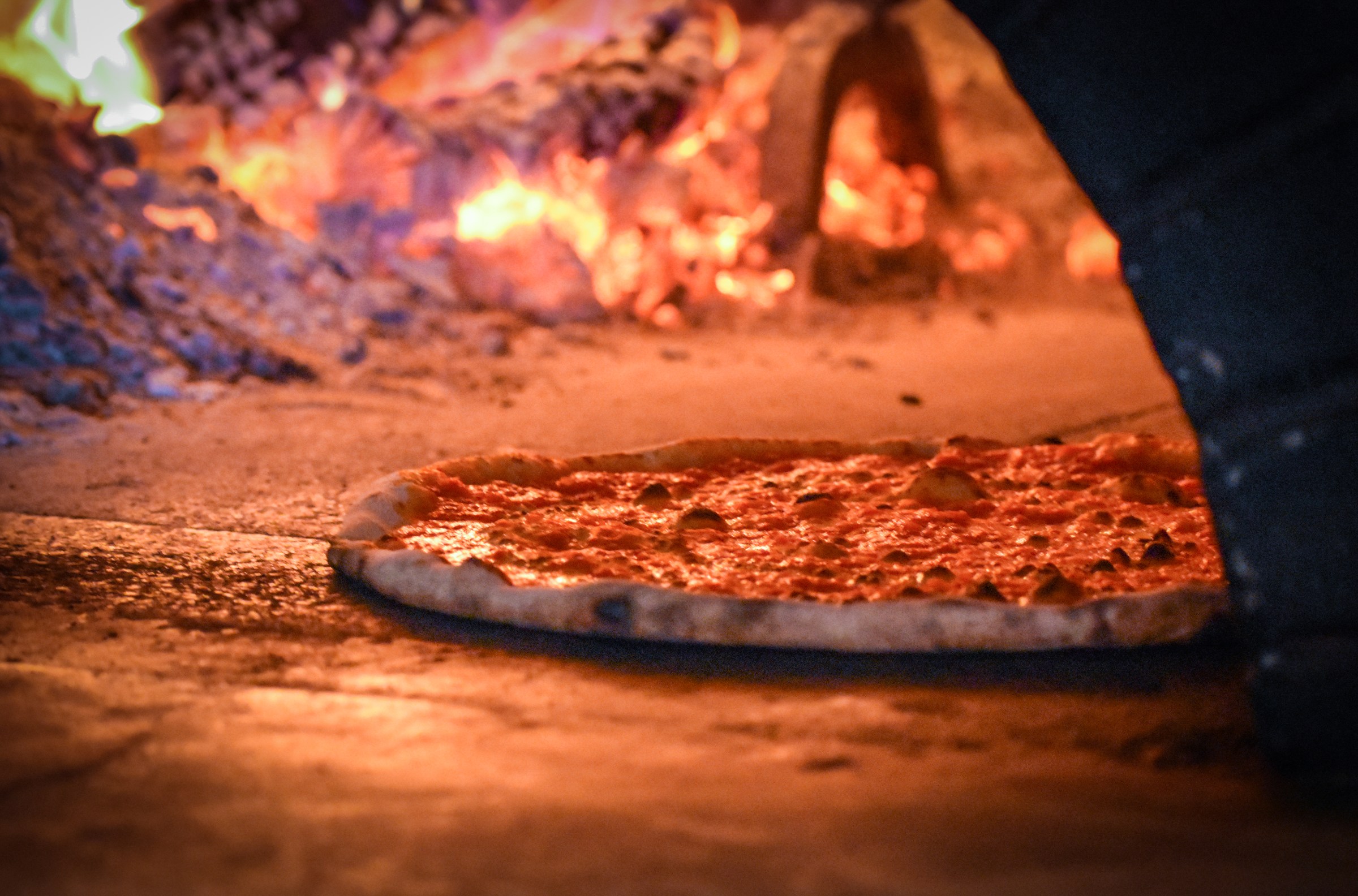 A pizza cooking in the restaurant’s wood-fired Italian oven at La Parolaccia.