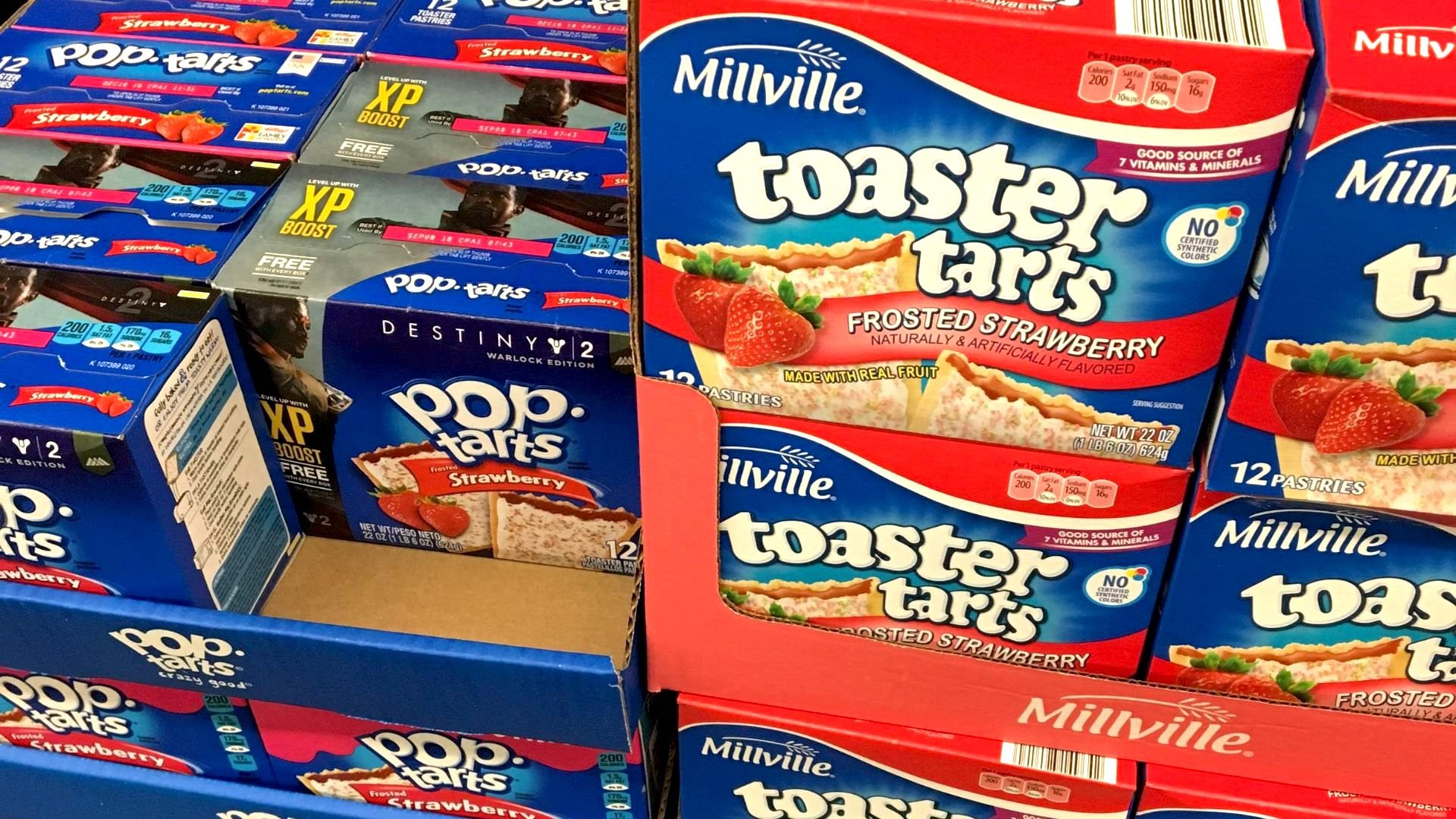 Boxes of Pop-Tarts and Millville Toaster Tarts, both strawberry flavored, are stacked side by side on store shelves. The packaging features images of the pastries with strawberry filling.