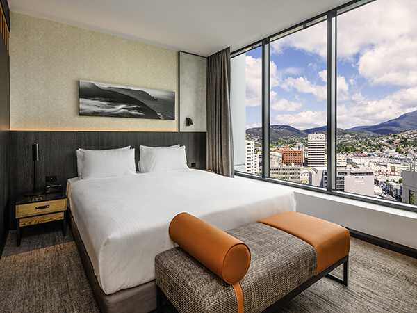 A stylish, Tasmanian-inspired bedroom at Mövenpick Hotel Hobart, your perfect base for relaxing after the best day trips from Hobart.