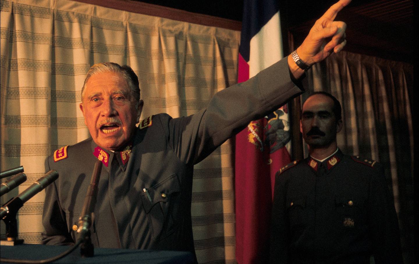 Pinochet pointing upward
