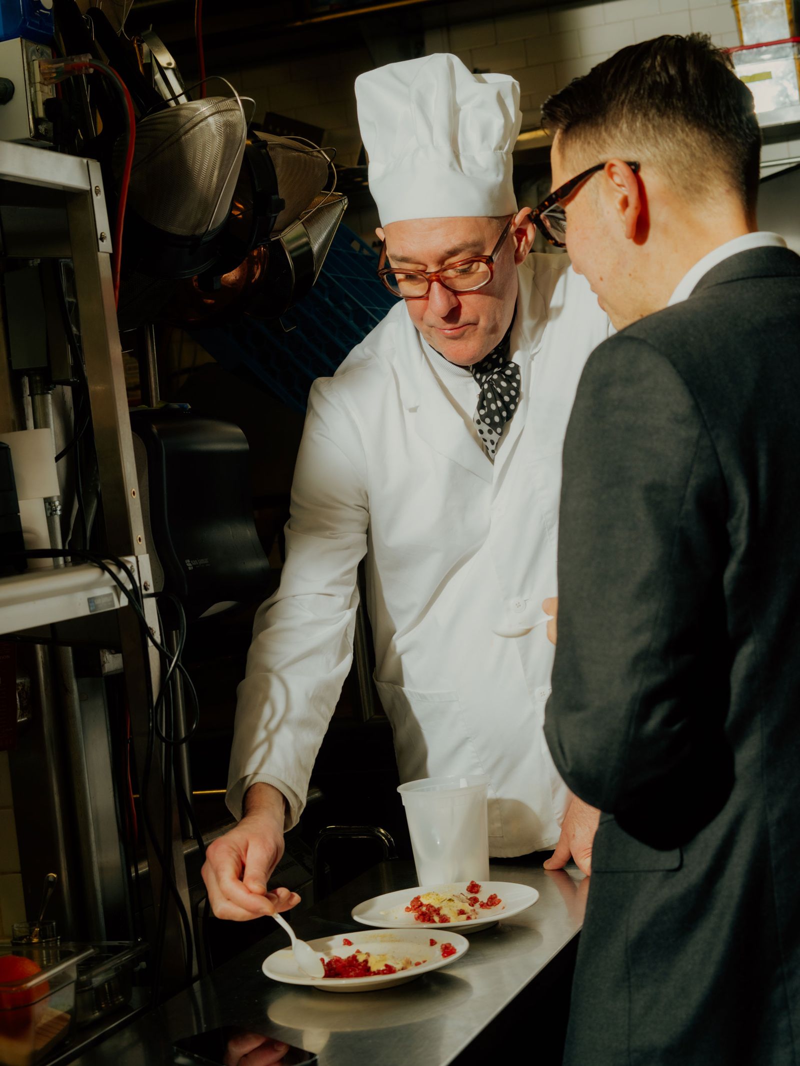 A chef plates a dish.