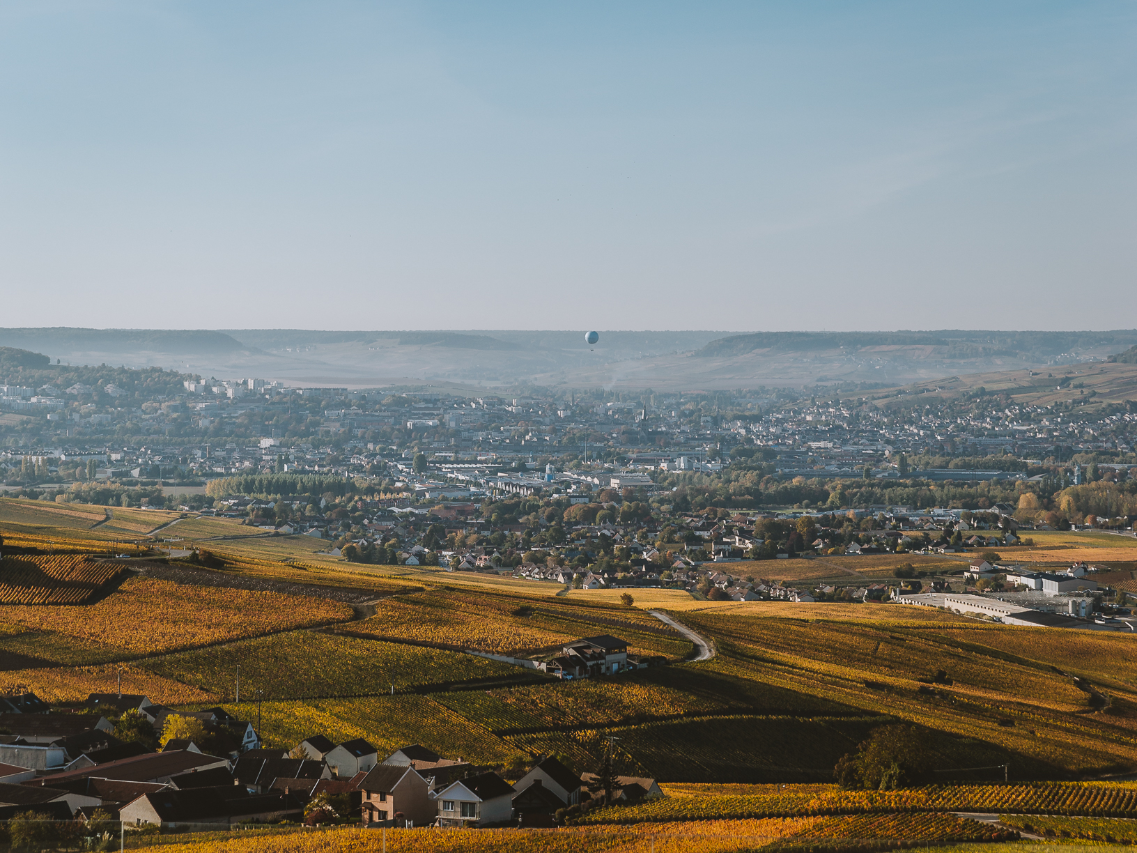 A hot air balloon soars over the hills of Champagne. 