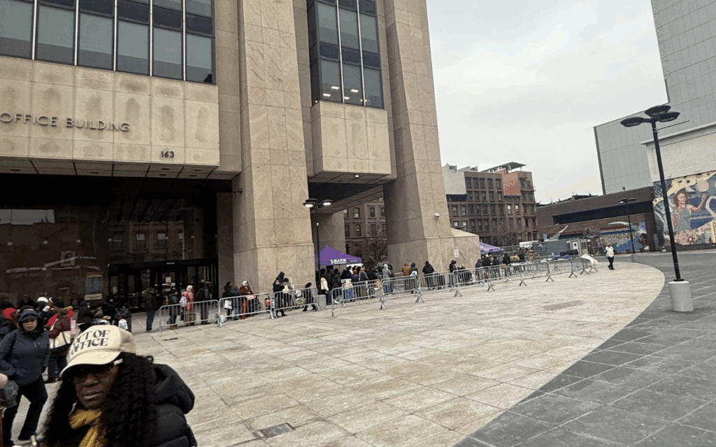 People lined-up at the Adam Clayton Powell Jr. State Office building to collect food donations. (Credit: Kai Adjetey)
