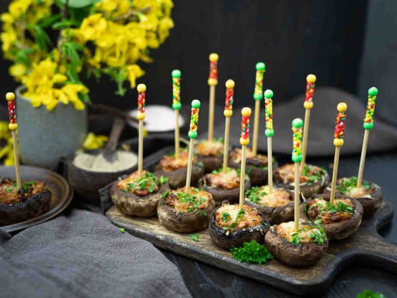 Mushrooms with toothpicks on sticks.
