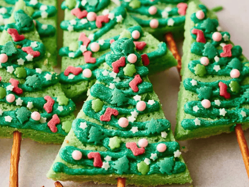 Christmas tree shaped cookies on a baking sheet.