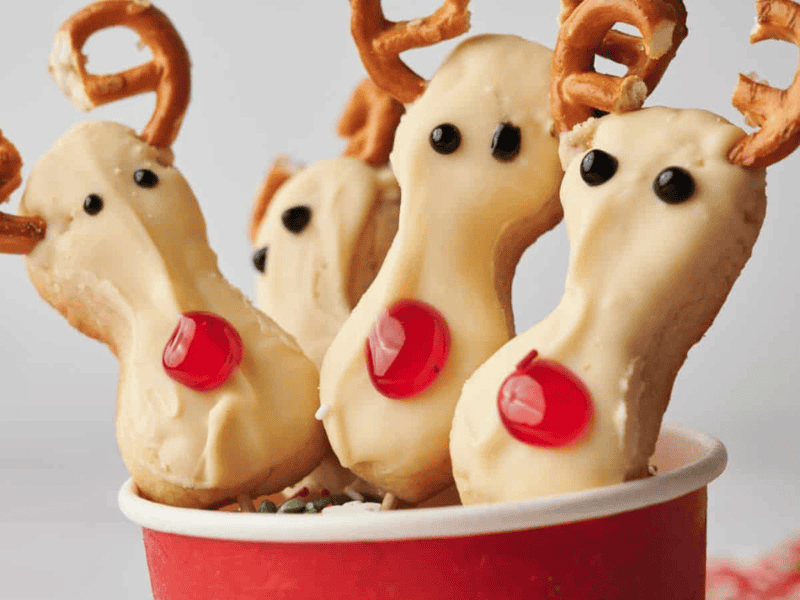 Reindeer cookie pops in a cup.
