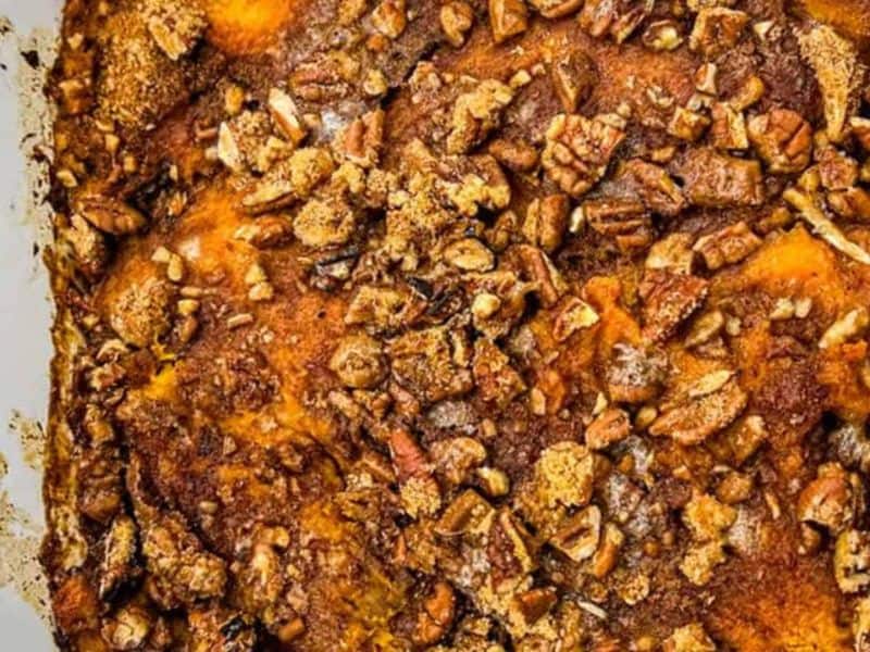 A close-up of Sweet Potato Casserole on a white dish.