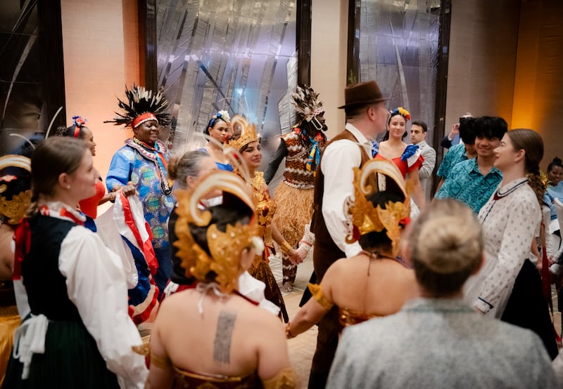 Performers gather to share their dances as part of a cultural celebration at a Christmas dinner hosted by the Church of Jesus Christ of Latter-day Saints in Geneva, Switzerland, in Dec. 2025.