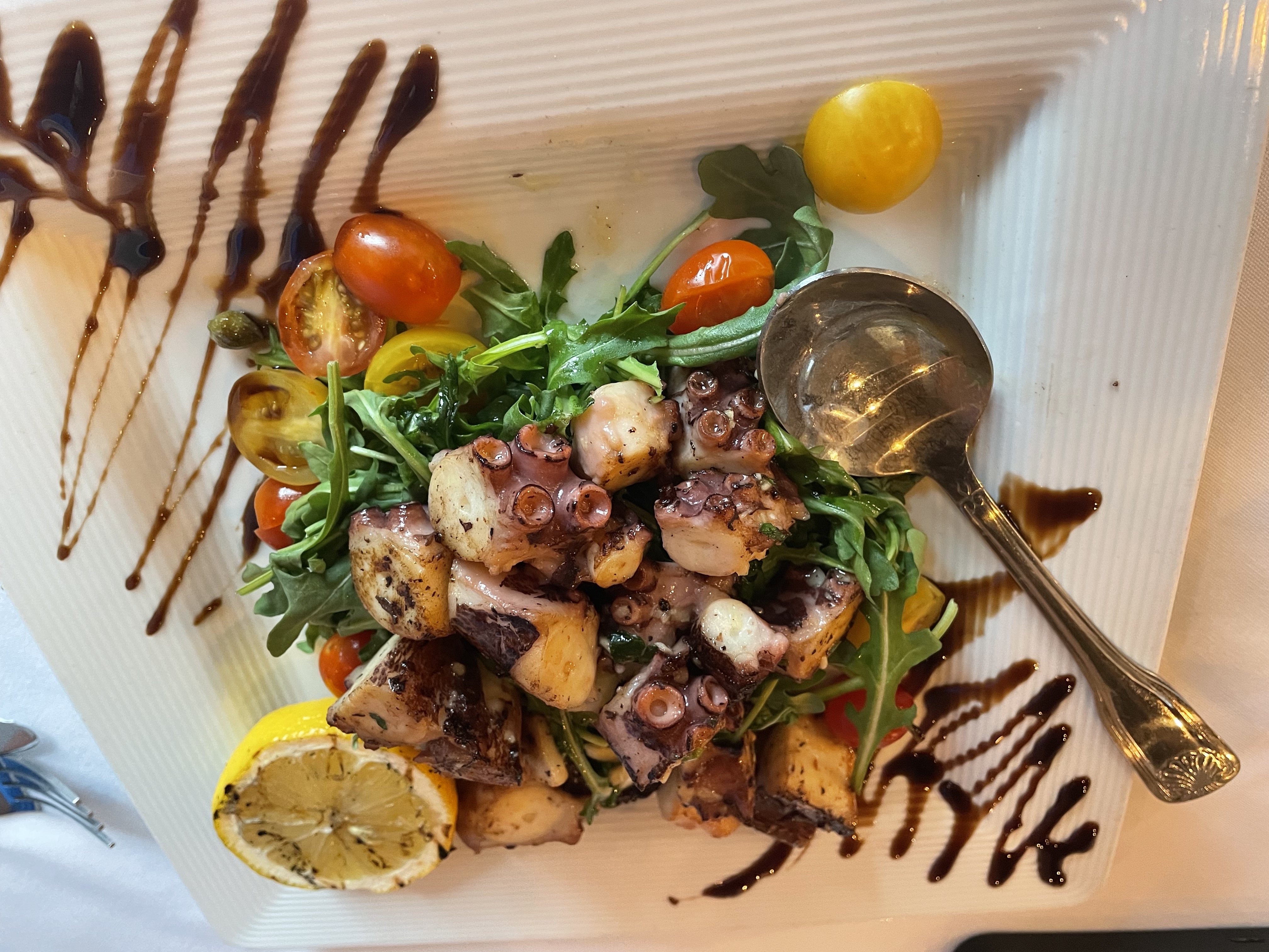 Grilled octopus is served with Amalfi lemon oil and oregano...