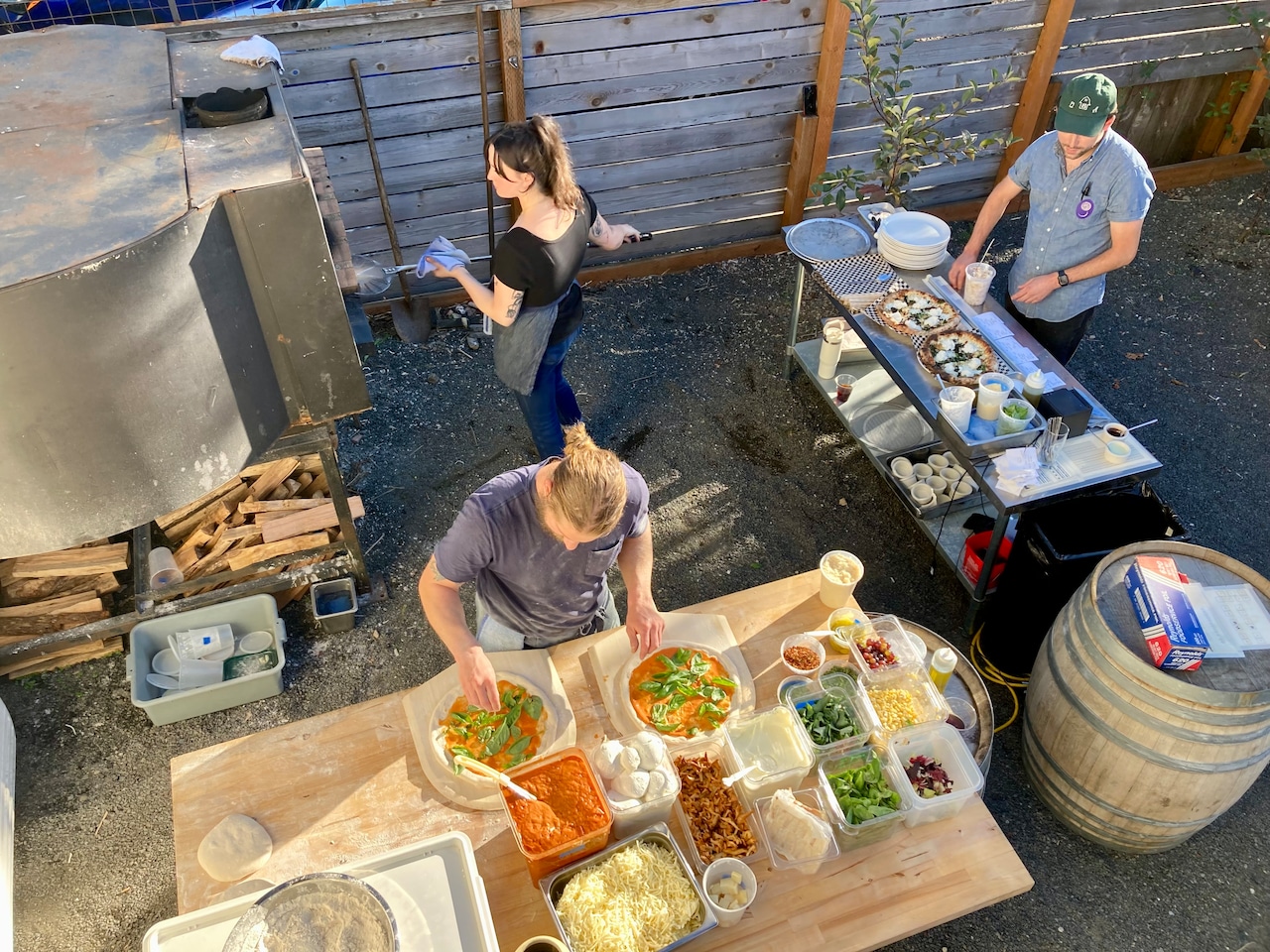 Clockwise from top left: Alexandra Williams, Daniel Green and Chris Leimena prep pizzas in what might be Portland's most famous oven.