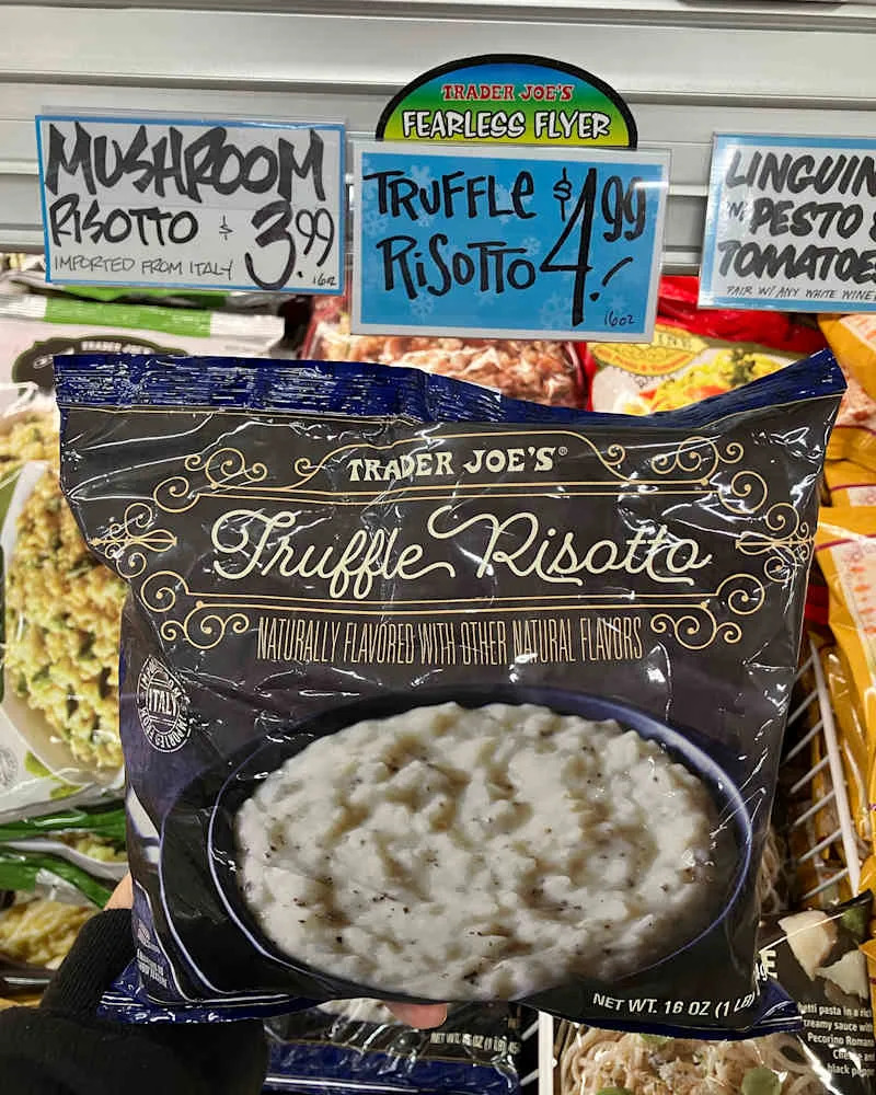 Someone holding Trader Joe's Truffle Risotto package.