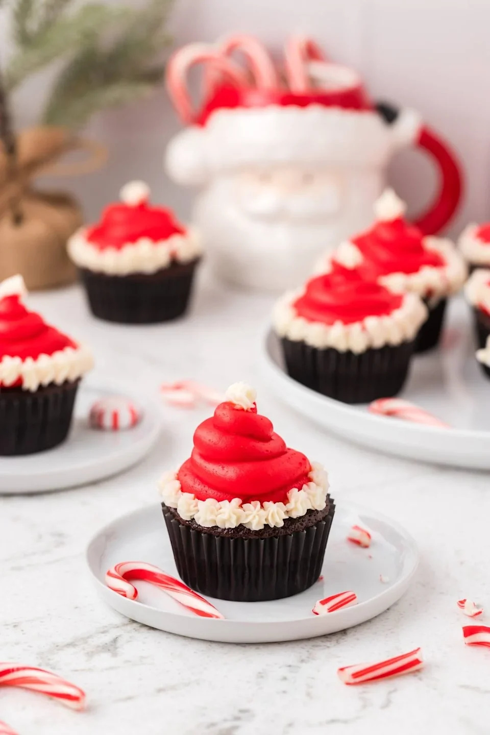 A close up shot santa hat cupcakes.