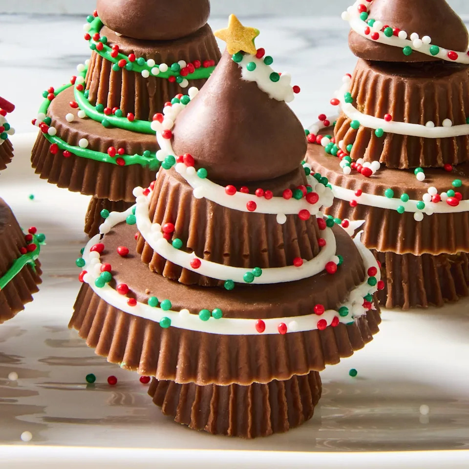 stacked reese's to make a christmas tree with icing and sprinkles