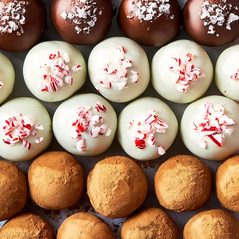 chocolate truffles topped with candy canes, sea salt, and cocoa powder