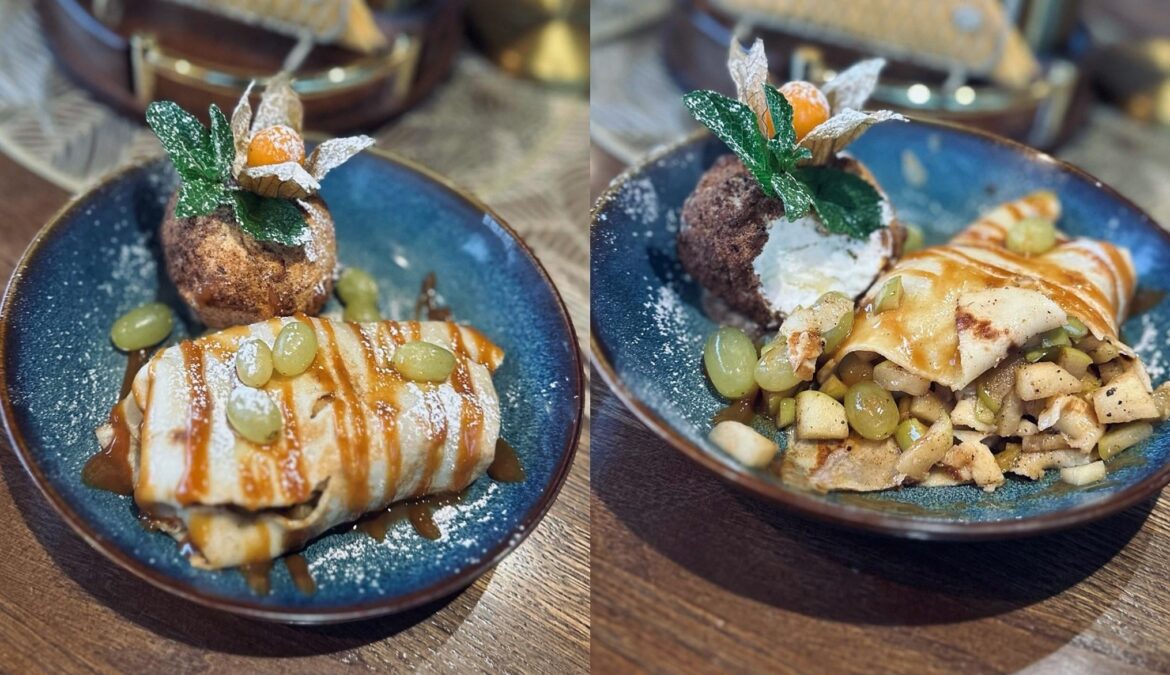 Pancake filled with baked apple, served with caramel sauce, grapes and ice cream