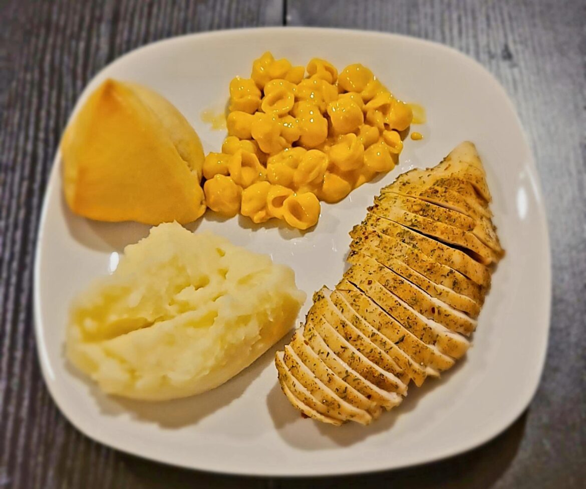 Baked chicken, shells and cheese, mashed potato and rolls