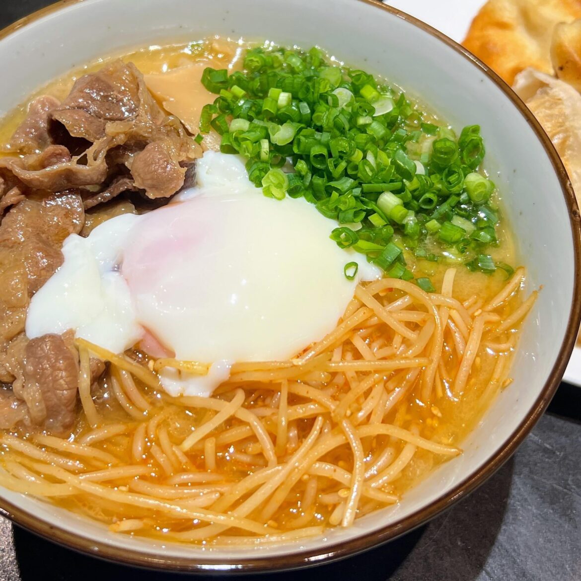 Sukiyaki Ramen - tonkotsu broth, pork fat, short plate, onsen egg, menma, moyashi (bean sprouts), and green onion