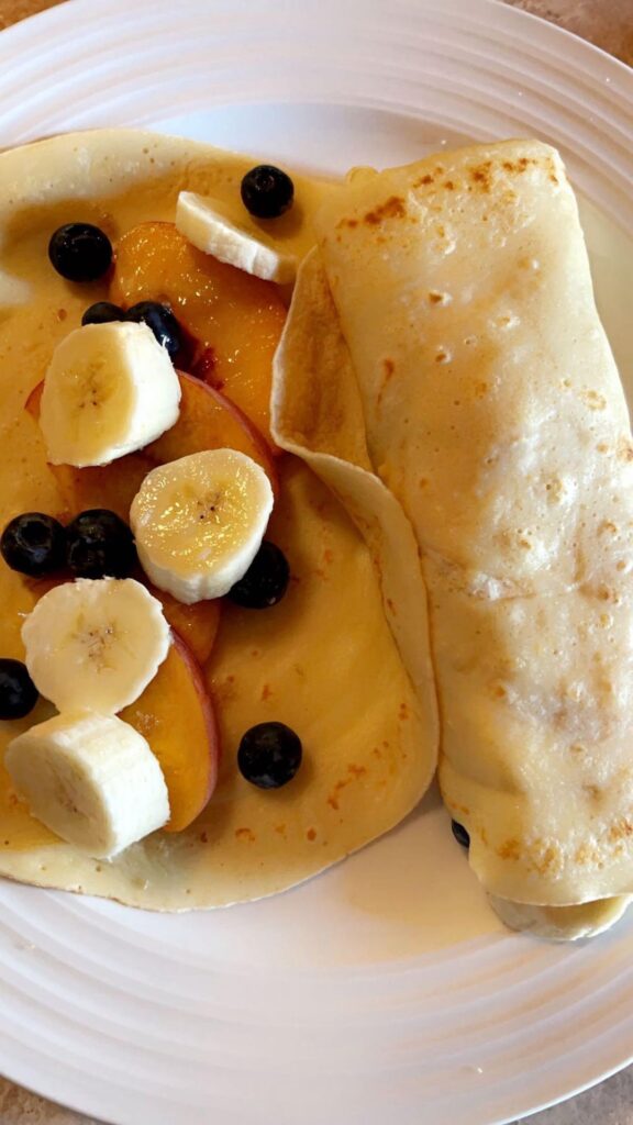 Crepes filled with peaches, bananas, & blueberries