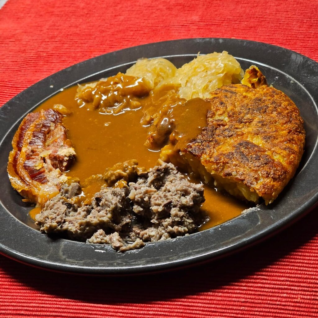 Veal liver sausage, with slowcooked bacon and sauerkraut, accompanied by a rösti made from scratch