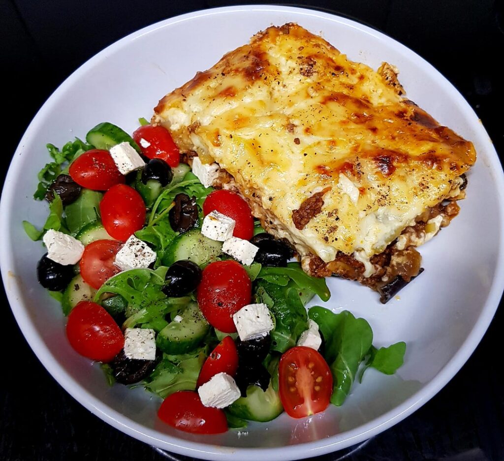 Mousakka. Topped with an Egg Bechemel and Greek Salad on the Side.