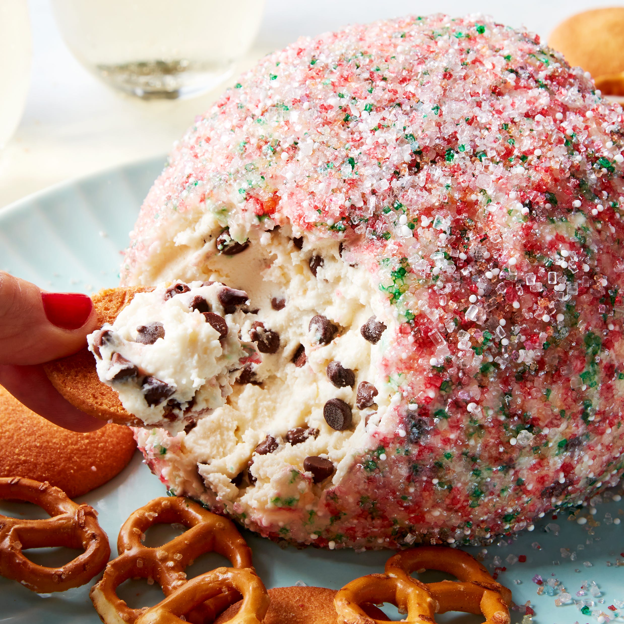 chocolate chip cookie dough ball rolled in sprinkles served with pretzels and nilla wafers