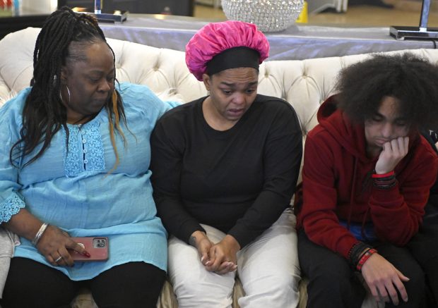 Katrina Smith, from left, sits with her daughter Leandrea Hernández, center, and Hernández' son Aiden Hernández, 13, as they talk about the Christmas Eve fire that destroyed their home in Zion, Dec. 27, 2025. (Michael Schmidt/for the Chicago Tribune)