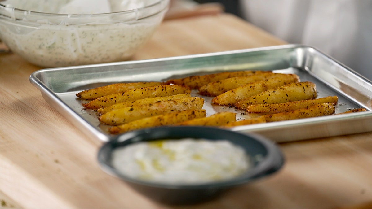 A platter of Cypriot Cinnamon Potatoes with Tzatziki.