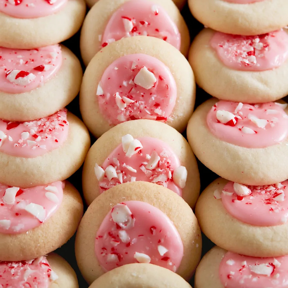 peppermint meltaway cookies topped with pink icing and crushed peppermints