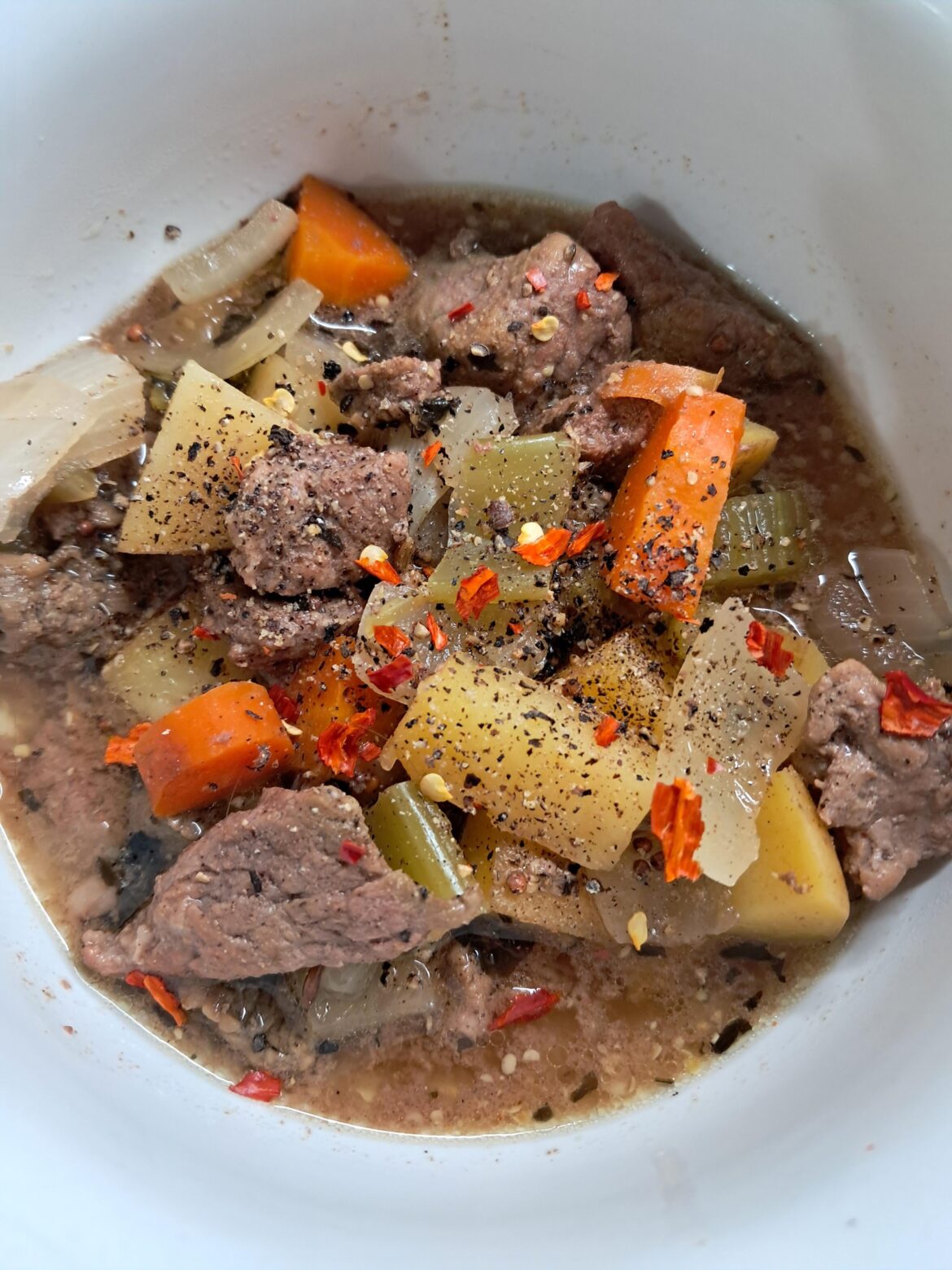 Slow-cooked beef stew with fresh ground black pepper and cayenne