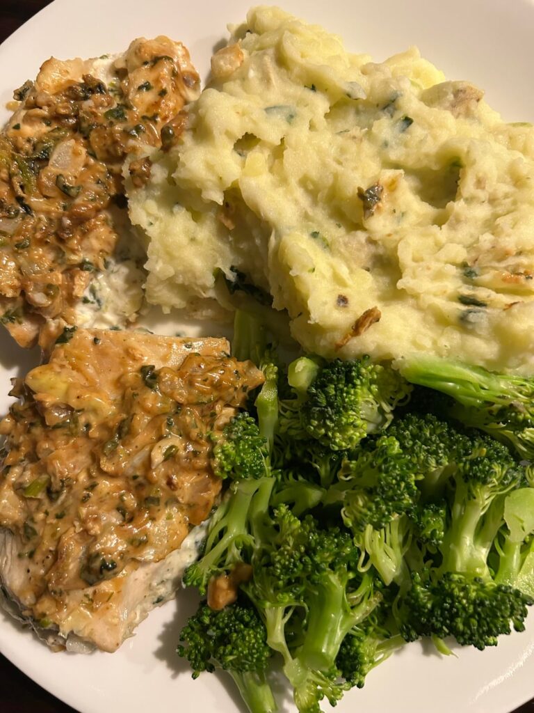 Chicken stuffed with spinach artichoke dip, mashed potatoes (flavored with extra dip mixture), and broccoli