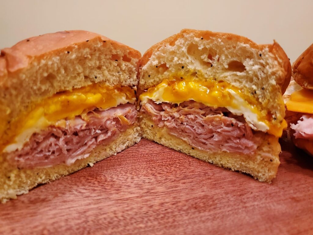 Ham egg American cheese breakfast sandwich on soft onion roll.