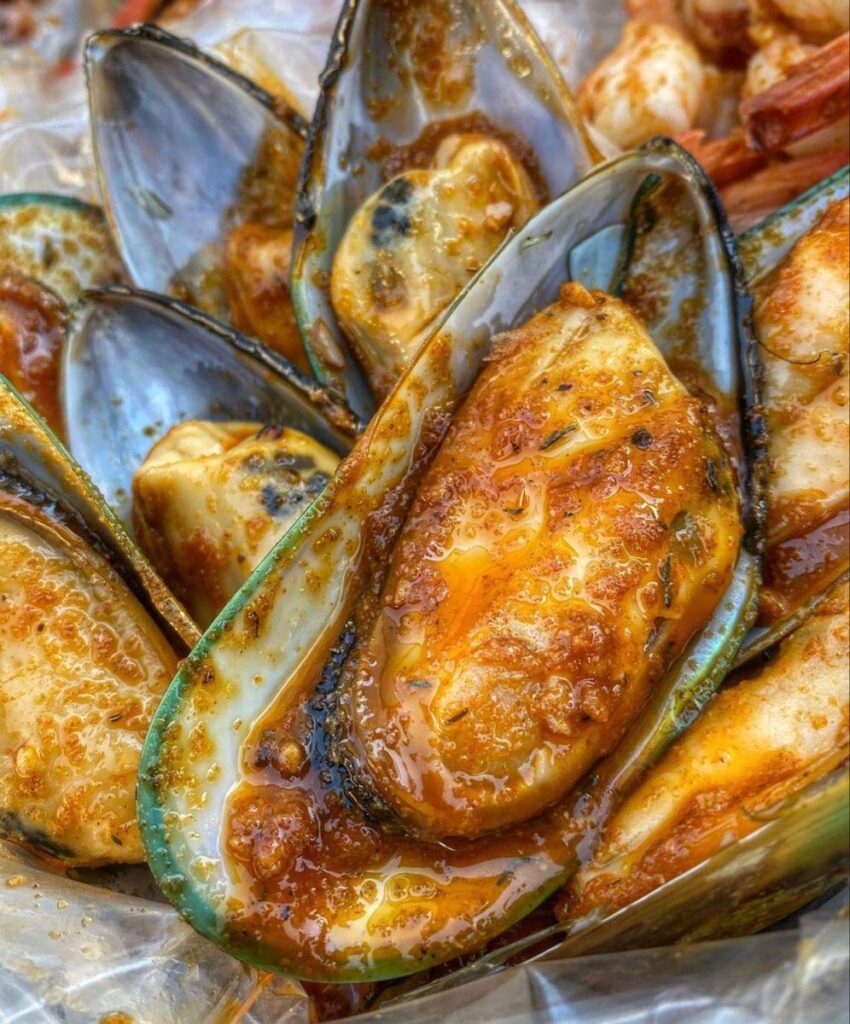 Steamy mussels bathed in a rich, spicy garlic sauce messy, bold, and absolutely irresistible.