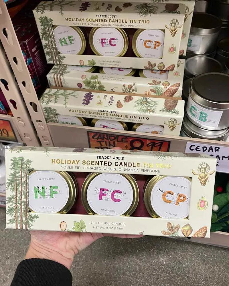 Someone holding Trader Joe's scented candle variety pack.