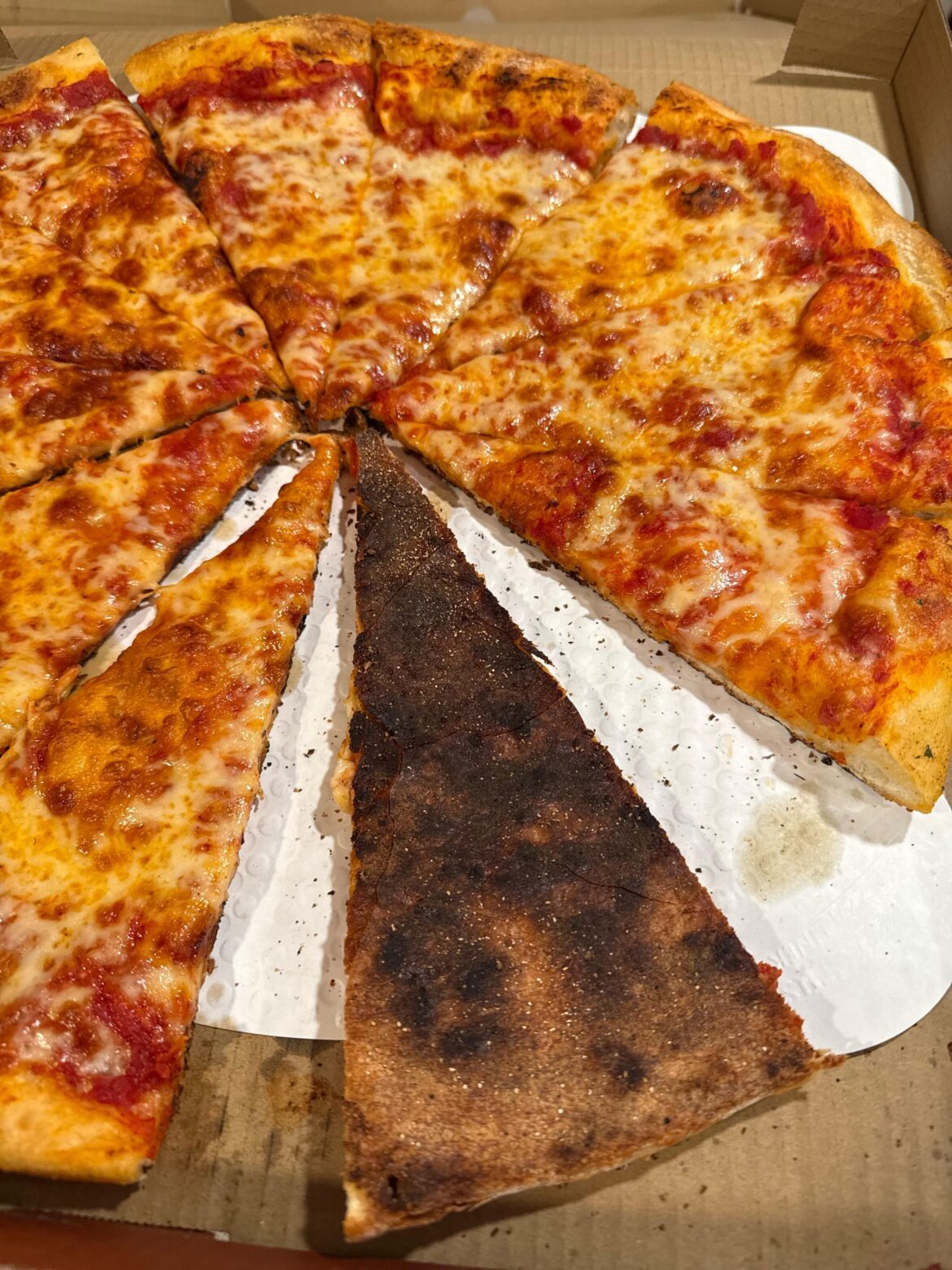 Pizza connoisseurs, is this pizza crust considered burnt? First one was worse, this is the replacement they delivered. This is from a small local pizza chain.