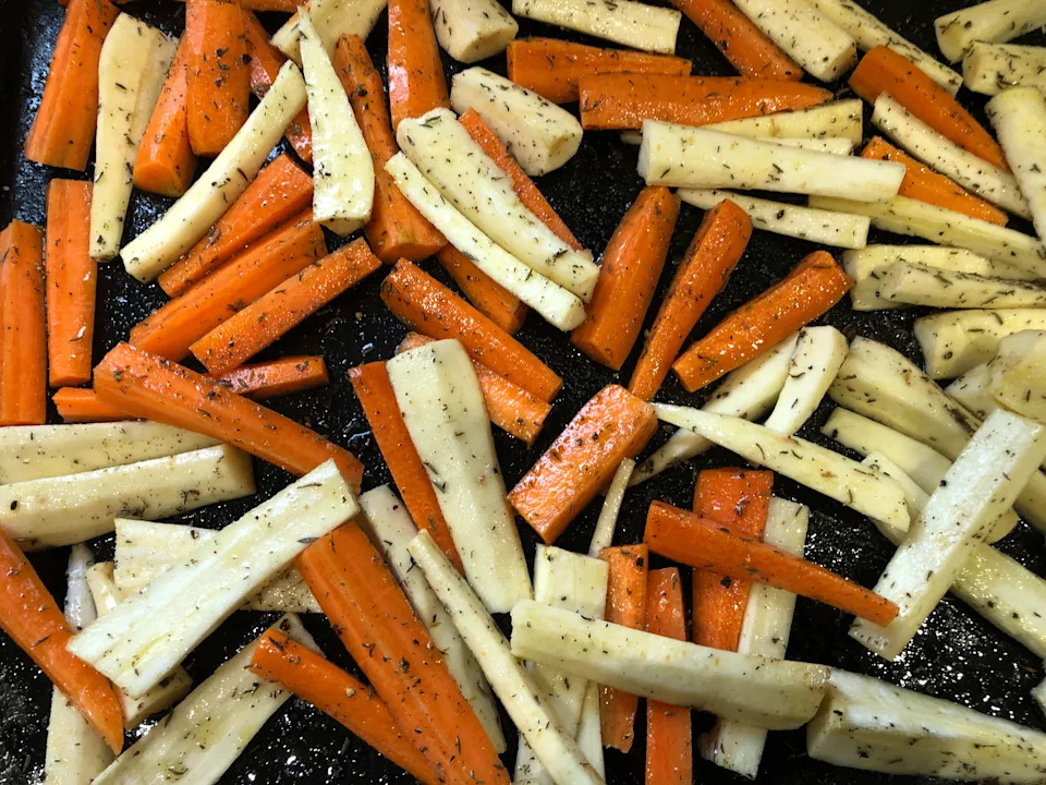 Carrots and parsnips on a tray for baking