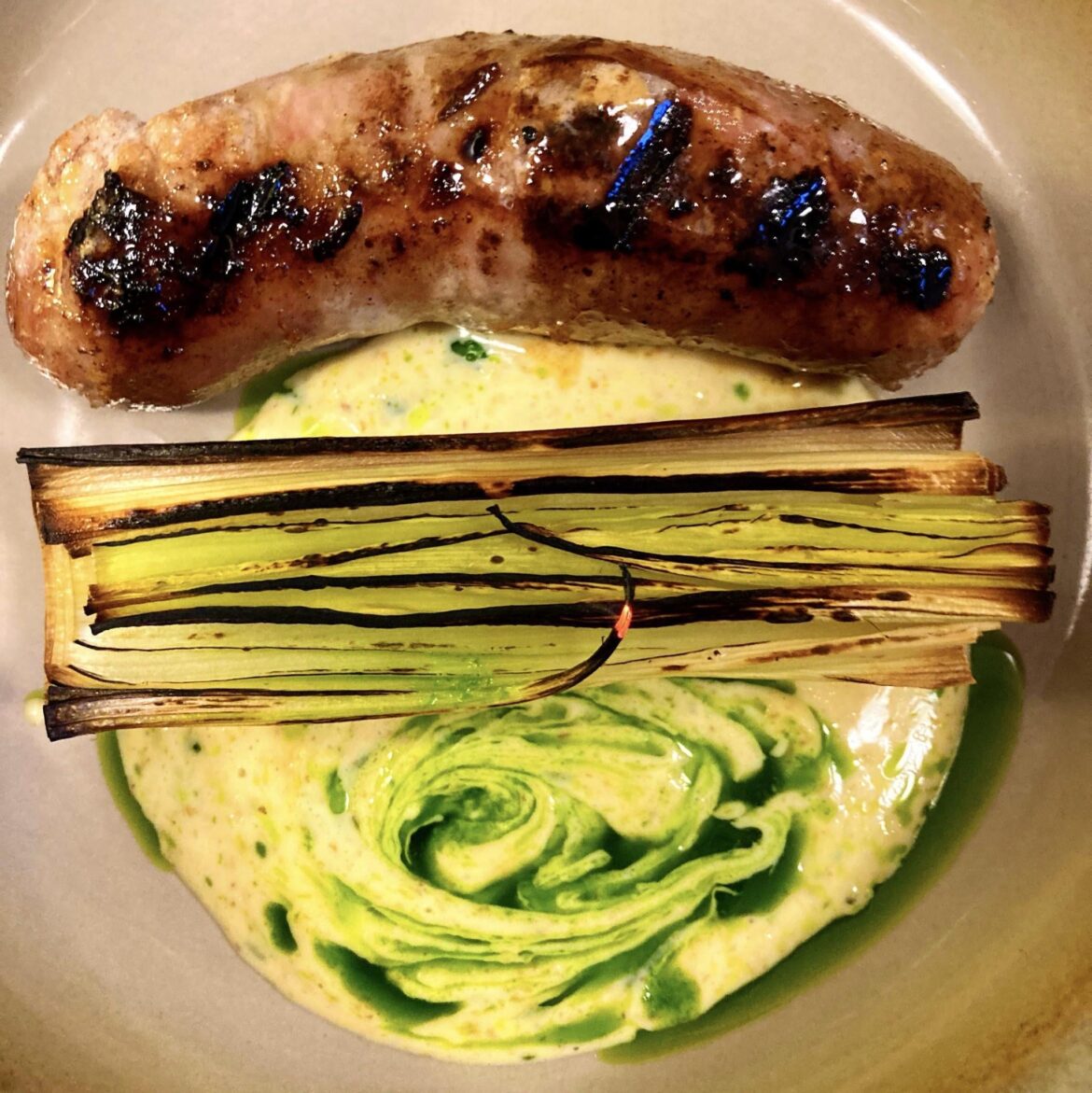 Home made pork & forced rhubarb sausage w/ fired leek, burnt creme double & jalapeno rapeseed oil.